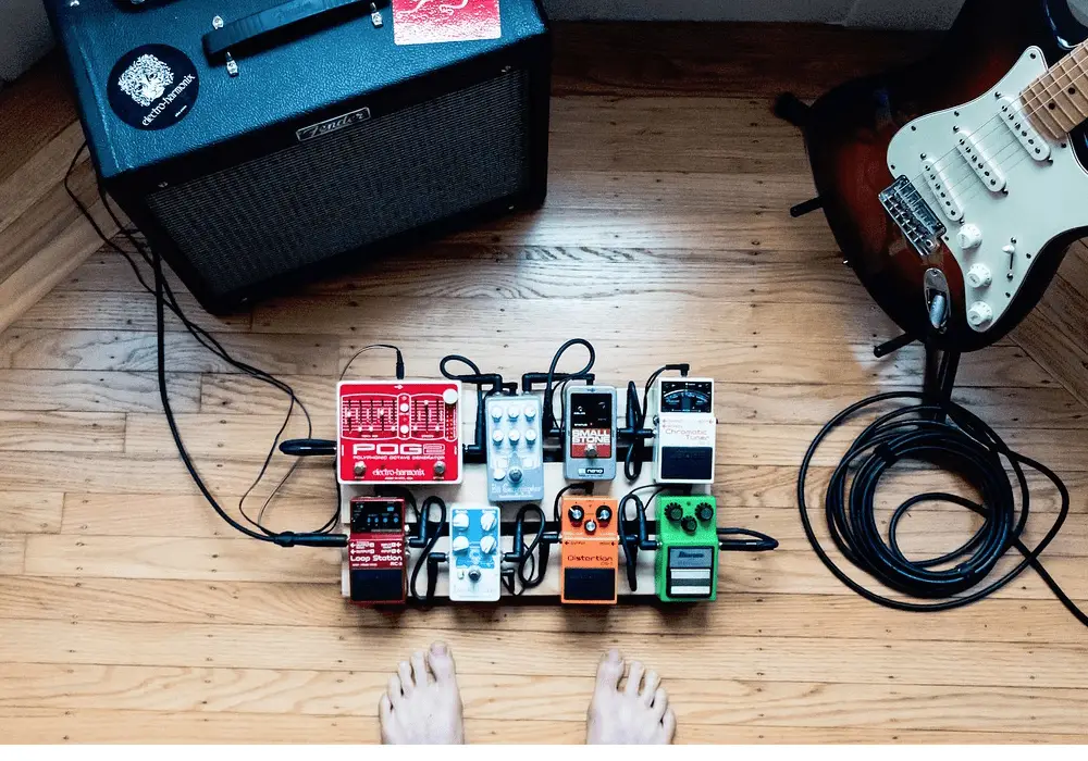 guitar pedals plugged into an amplifier with electric guitar